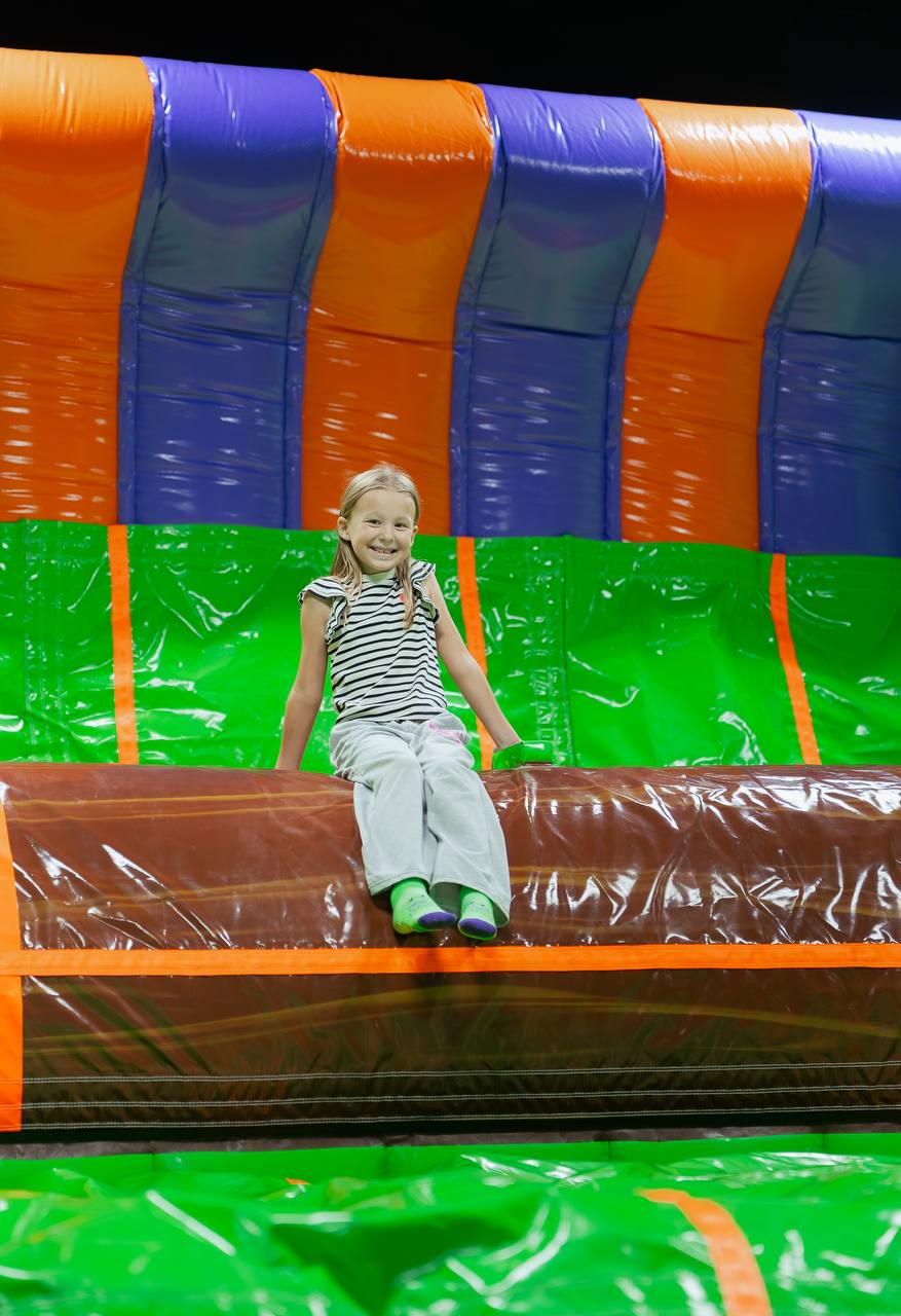 Girl on an inflatable slide at the indoor playground in Crystal Lake, IL